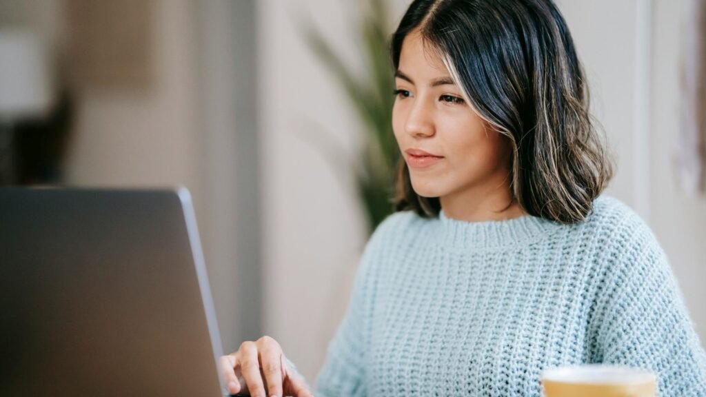 A girl designing a logo design on her laptop to improve brand identity