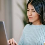 A girl designing a logo design on her laptop to improve brand identity
