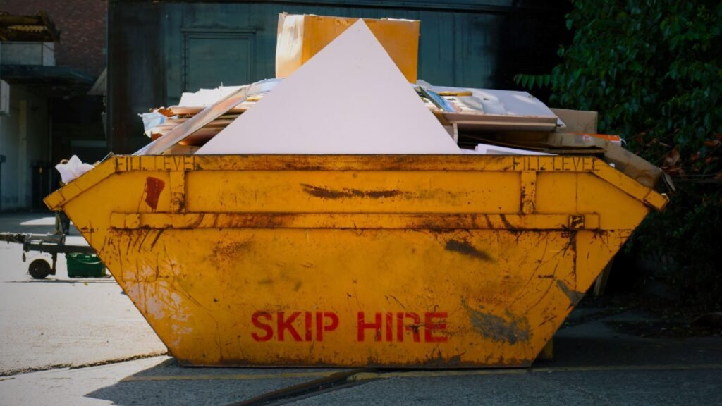 A yellow overloaded container from skip services managing household waste